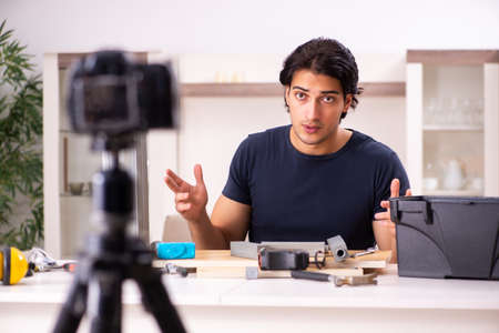 Young male repairman recording video for his blogの写真素材