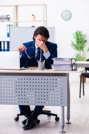 Young businessman sitting and working in the officeの写真素材