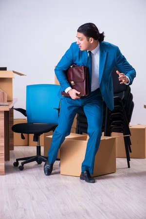 Young handsome businessman being fired from his workの写真素材
