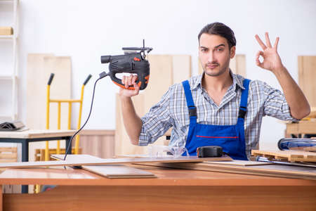 Young male carpenter working indoorsの写真素材