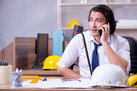 Young male architect working in the officeの写真素材