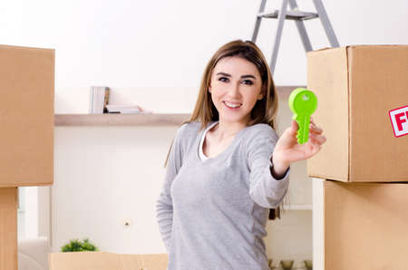 Young beautiful woman moving to new flat
