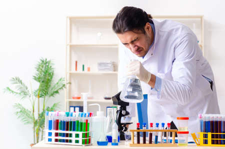 Young male chemist working in the lab