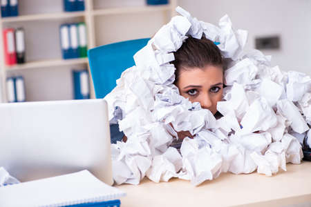 Businesswoman rejecting new ideas with lots of papersの写真素材