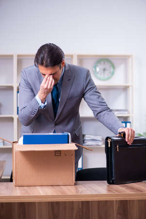 Young male employee being fired from his workの写真素材
