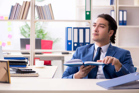 Young handsome employee in the officeの写真素材