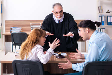 Young couple in the courthouse in divorce conceptの写真素材