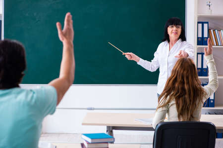 Old teacher and students in the classroom