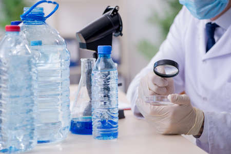 Young male chemist experimenting in labの写真素材