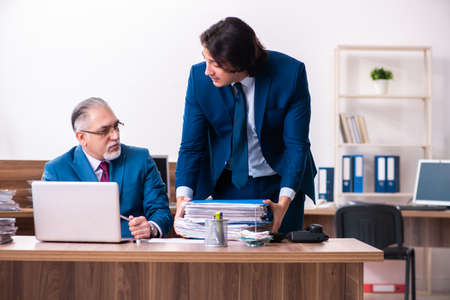 Young and old employees working together in the officeの写真素材