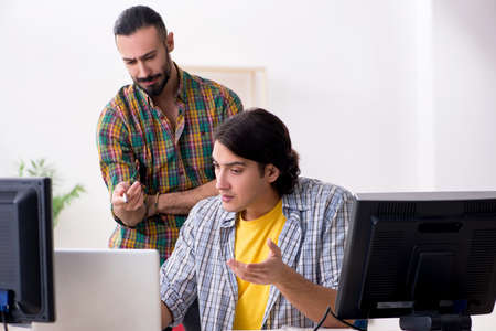 Two it specialists working in the office