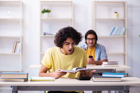 Two male students in the classroomの写真素材