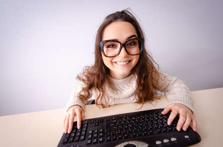 Funny nerd girl working on computerの写真素材