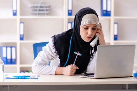 Young doctor in hijab working in the clinicの写真素材