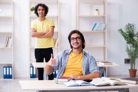 Two male students in the classroomの写真素材