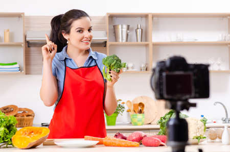 Young female vegetarian recording video for her blogの写真素材