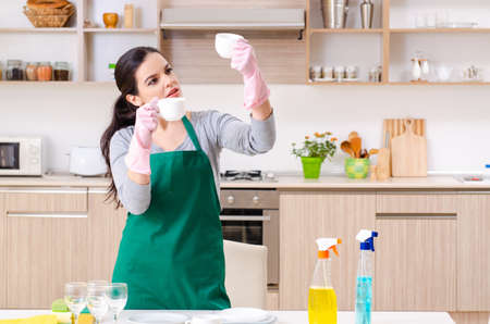 Young female contractor doing housework