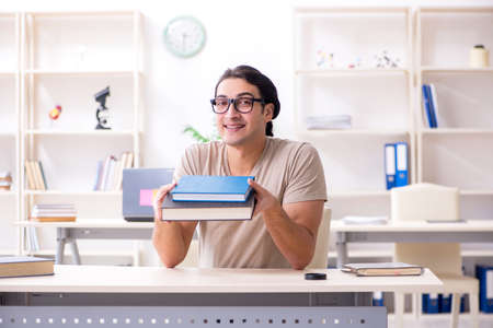 Young male student preparing for exams at homeの写真素材