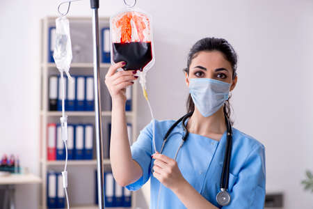 Young female doctor in infusion conceptの写真素材