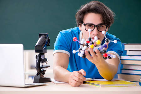 Young male student in the classroom