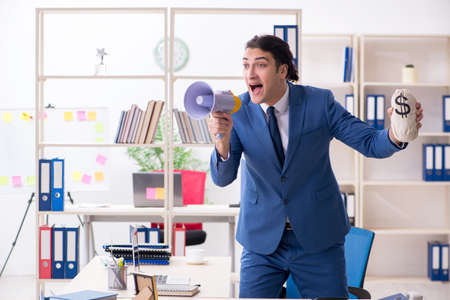 Young handsome employee in the officeの写真素材