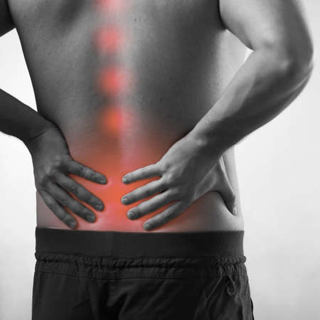 Man suffering from acute pain in spine back