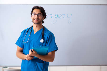 Young male doctor in front of whiteboardの写真素材