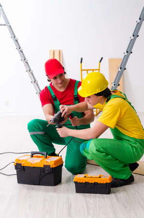 Two workers contractors working indoorsの写真素材