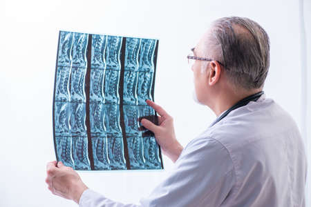 Old male doctor working in the clinicの写真素材