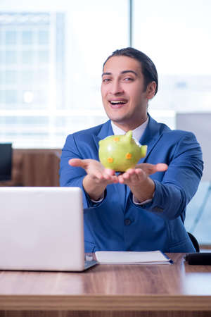 Young handsome businessman sitting in the officeの写真素材