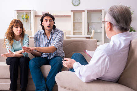 Young pair visiting experienced doctor psychologistの写真素材