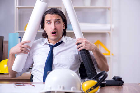 Young male architect working in the officeの写真素材