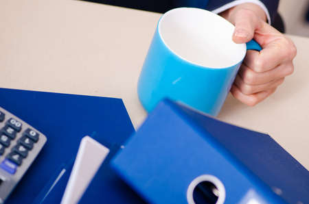 Middle-aged businesswoman unhappy with excessive workの写真素材