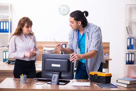 Young male it specialist in the officeの写真素材