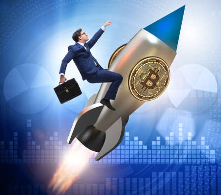Businessman flying on rocket in bitcoin price rising conceptの写真素材