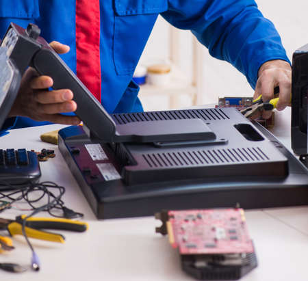 Professional repairman repairing computer in workshopの写真素材