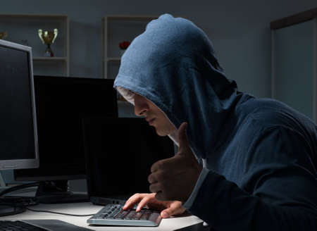 Hacker hacking computer at night