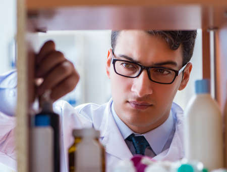 Doctor at farmacy retail shop looking for medicinesの写真素材