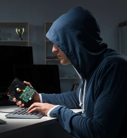 Hacker hacking computer at night