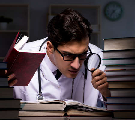 Medical student preparing for university exams at nightの写真素材