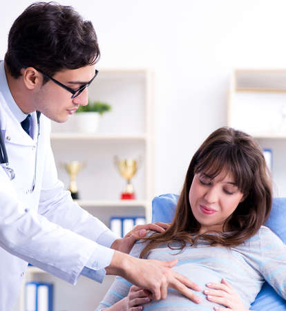Pregnant woman visiting doctor for consultationの写真素材