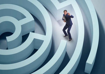 Businessman is trying to escape from maze labyrinthの写真素材