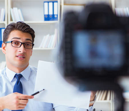 Business blogger doing webcast for his subscribersの写真素材