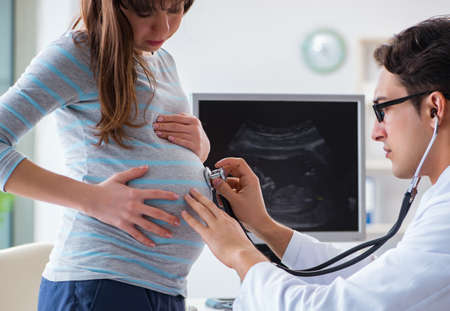 Pregnant woman visiting doctor for regular check-upの写真素材