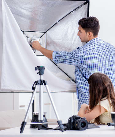 Young photographer working in photo studioの写真素材