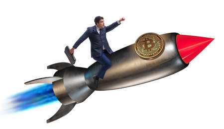 Businessman flying on rocket in bitcoin price rising conceptの写真素材