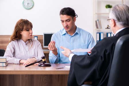 Young couple in the courthouse in divorce conceptの写真素材