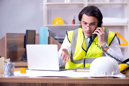 Young male architect working in the office
