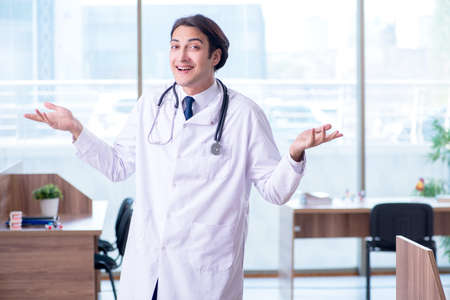 Young handsome doctor working in the clinicの写真素材