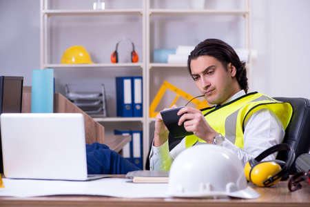 Young male architect working in the office